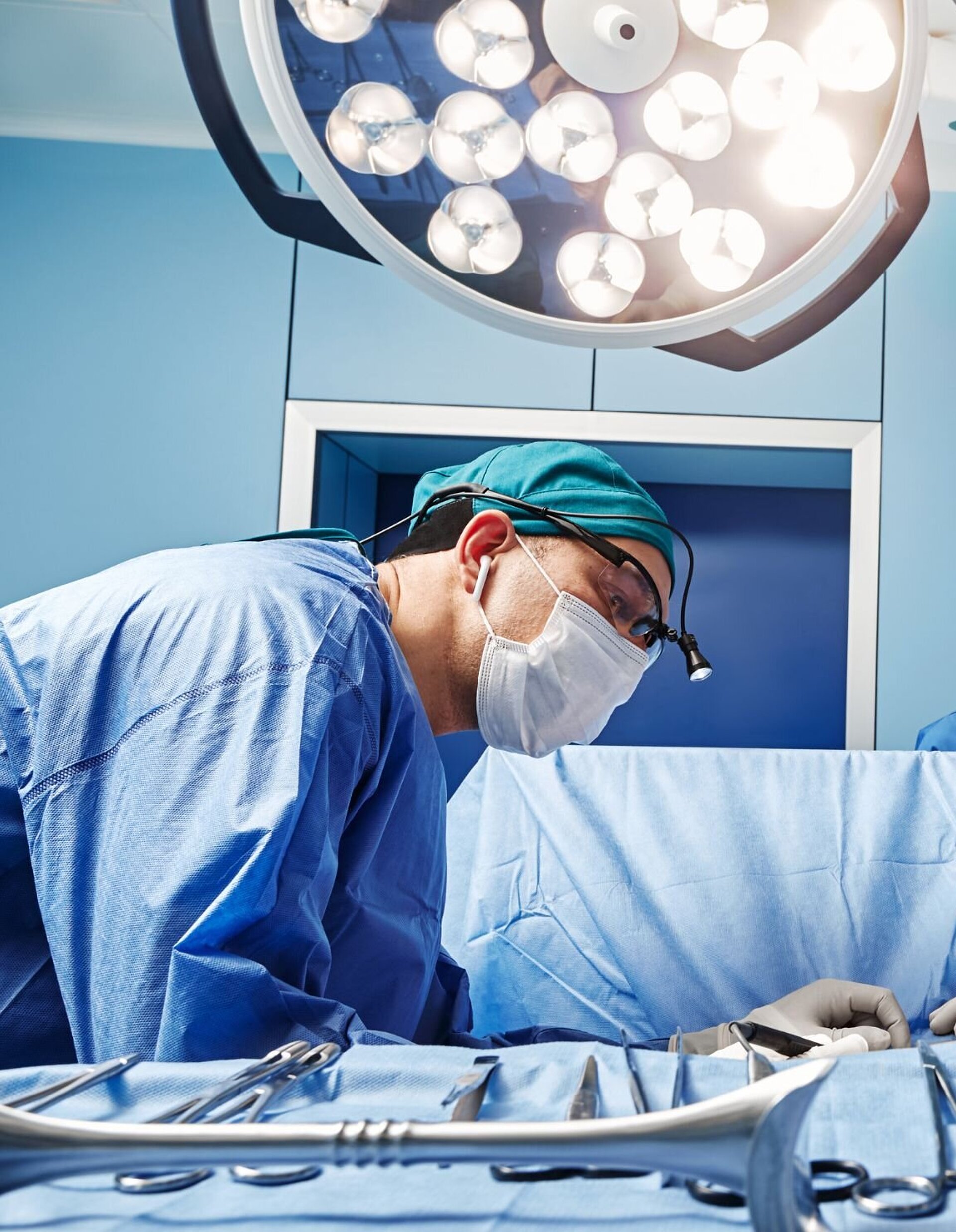 Four doctors working in an operating room, surrounded by modern specialized equipment.